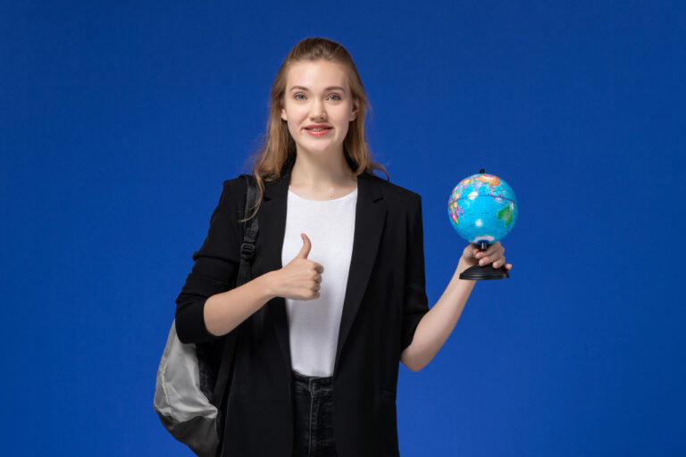 “Student holding globe showing study abroad and international travel opportunities.”